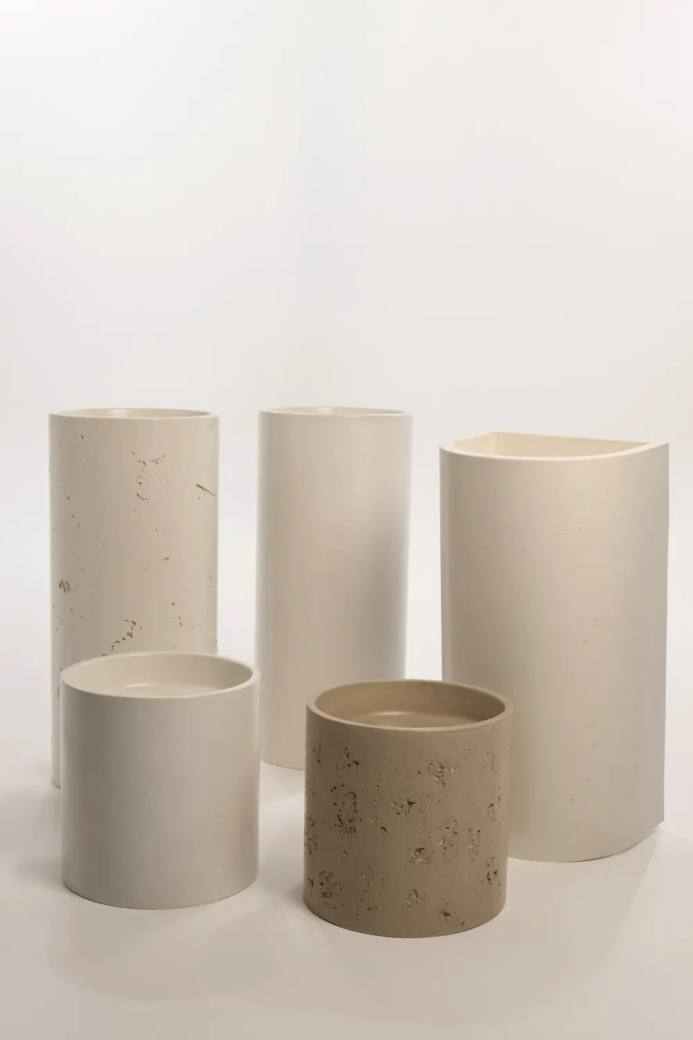 Collection of five concrete basins in varying heights and finishes