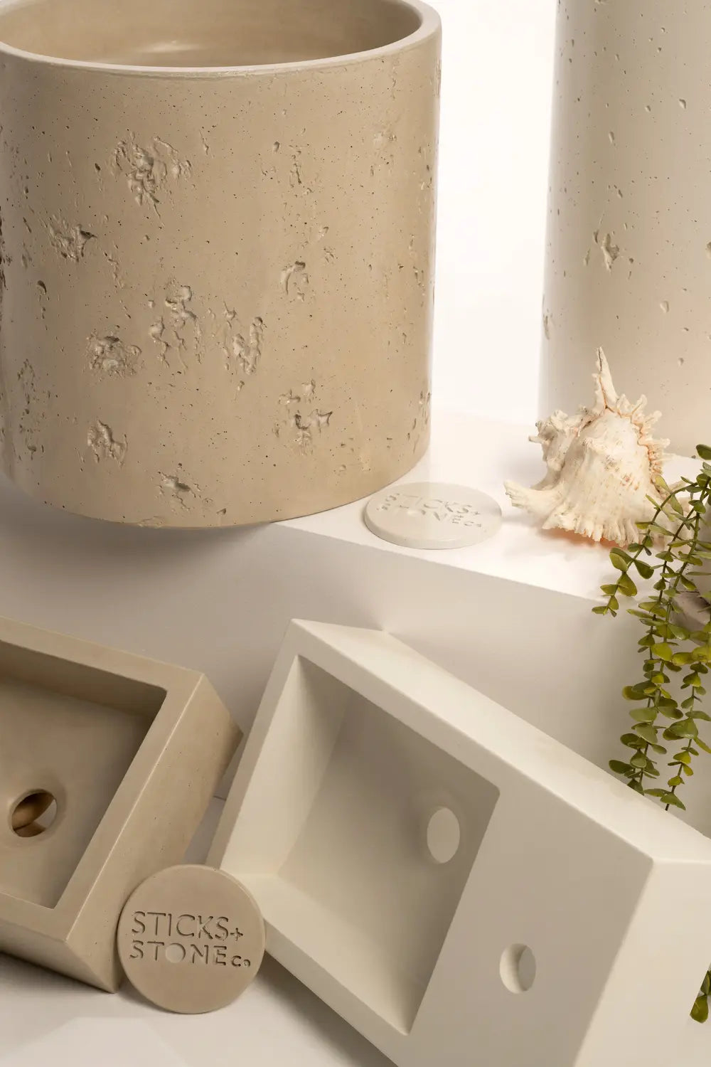 Close-up of textured basin surface and Sticks+Stone brand mark