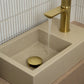 Concrete rectangular basin with brushed brass tap against white tiles