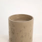 Taupe concrete pedestal basin showing rustic surface texture.